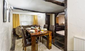 a dining room with a table and a couch at Birchcroft in Ambleside