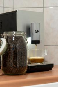 a coffee maker sitting next to a jar of coffee beans at Budapest Apartment in Budapest