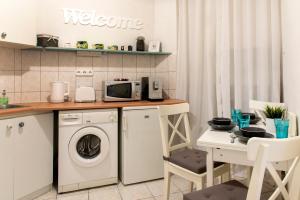 a kitchen with a washing machine and a microwave at Budapest Apartment in Budapest