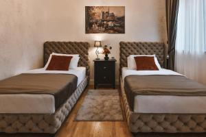 Postel nebo postele na pokoji v ubytování Garni hotel BARUT