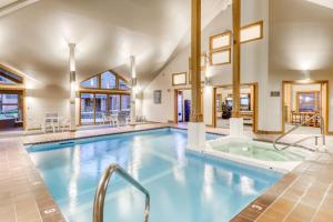 a large indoor swimming pool with a hot tub at Cozy Modern Comfort in Killington