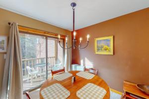 a dining room with a table and a balcony at Cozy Modern Comfort in Killington
