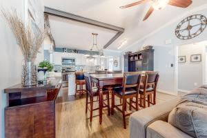 a kitchen and living room with a table and chairs at The Sand Dune in Ocean City +18 photos