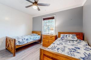a bedroom with two beds and a ceiling fan at The Sand Dune in Ocean City
