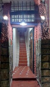 a staircase in a building with red brick walls at Dar Agham Akbou in Timimoun