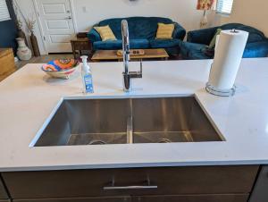 a kitchen sink in a kitchen with a couch at Scenic Southwest Hideaway, Perfect for Relaxation! in Phoenix
