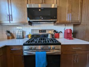 a kitchen with a stove and a microwave at Scenic Southwest Hideaway, Perfect for Relaxation! in Phoenix