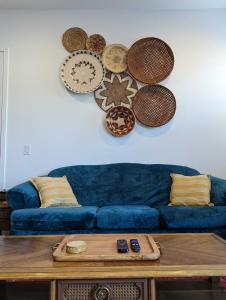 a living room with a blue couch and a table at Scenic Southwest Hideaway, Perfect for Relaxation! in Phoenix
