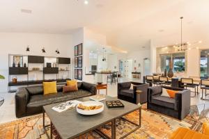 a living room with two couches and a table at Santal Estate - Play, Relax, Walk to the Festivals in Indio