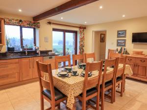 a kitchen and dining room with a table and chairs at Low House in Penrith