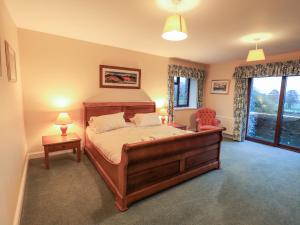 a bedroom with a large bed and a window at Low House in Penrith