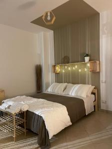 a bedroom with a large bed with lights on it at Macadà in Bari