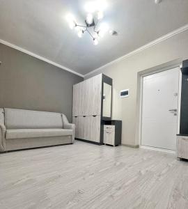 a living room with a couch and a cabinet at Beautiful Apartment in Chisinau in Chişinău