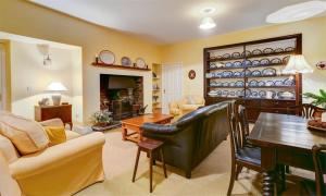 a living room filled with furniture and a table at Hawkshead Hall in Hawkshead