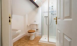 a white bathroom with a toilet and a shower at Hawkshead Hall in Hawkshead +24 photos