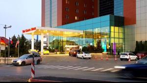 a parking lot with cars parked in front of a building at Bucharest Residence in Bucharest