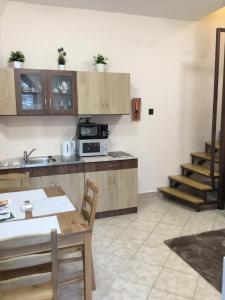 A kitchen or kitchenette at Kincsem Apartman