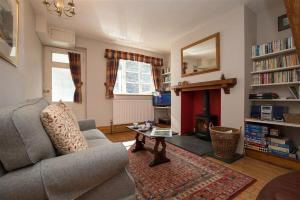 a living room with a couch and a fireplace at Briardale Cottage in Ambleside