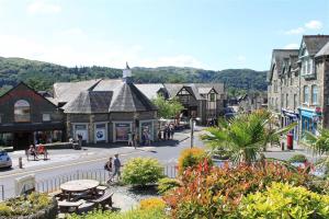 a town with people walking on a street with buildings at Briardale Cottage in Ambleside +4 photos