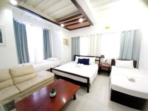 a living room with two beds and a couch at SOFIATEL Rooms in Santa Maria
