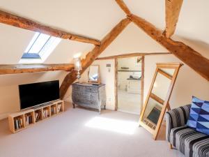 a living room with a tv and a couch at The Low House in Kendal