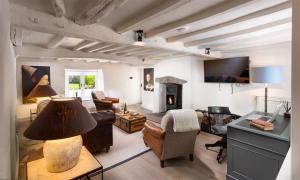 a living room filled with furniture and a fireplace at Underhowe in Grasmere