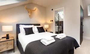 a bedroom with a bed with white towels on it at Underhowe in Grasmere
