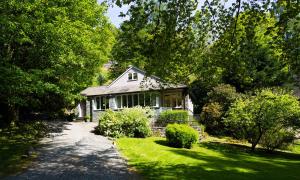 a white house with a pathway in front of it at Underheron in Grasmere
