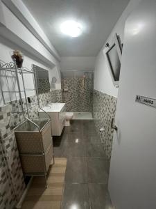 a bathroom with a toilet and a sink and a shower at Sun Beach Arinaga in Arinaga