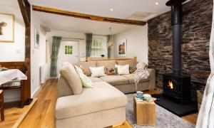 a living room with a couch and a fireplace at Pennys Cottage in Troutbeck