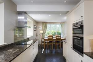 a kitchen with a table and a dining room at Cherry Garth in Patterdale