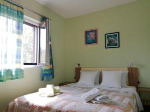 a bedroom with a bed with towels on it at Apartment Njivice 5320b in Njivice