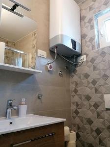a bathroom with a sink and a mirror at Apartment Njivice 5320b in Njivice