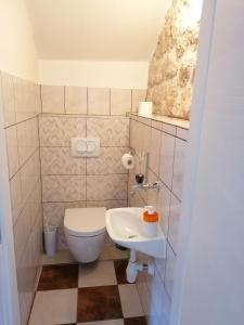 a small bathroom with a toilet and a sink at Apartment Njivice 5320b in Njivice