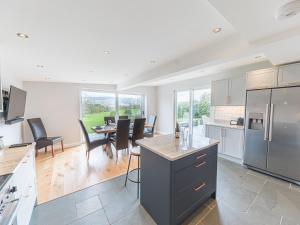 a kitchen and dining room with a table and chairs at Cedar Wood Coniston in Coniston