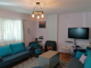 a living room with blue couches and a tv at Apartments with a parking space Njivice, Krk - 5320 in Njivice