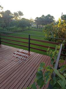 a wooden deck with a fence in a park at Departamentos Temporarios Aeropuerto in Formosa