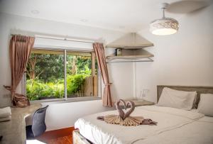 a bedroom with a bed with a towel on it at Filou Studio Golf Pool Access 29 67 in Ko Chang