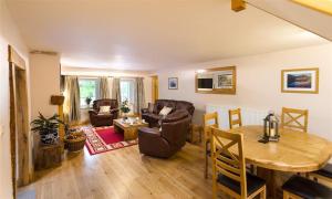 a living room with a table and a dining room at Scalegill House in Cockermouth