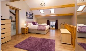 a large bedroom with two beds and a bathroom at Scalegill House in Cockermouth