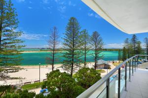 a balcony with a view of the beach and water at Rumba Beach Resort in Caloundra