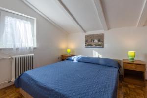 a bedroom with a blue bed and a window at Apartments with a parking space Karigador, Novigrad - 2534 in Karigador