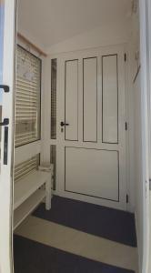een witte deur in een kamer met een bank bij Holiday house with a parking space Kastel Stari, Kastela - 20226 in Kaštel Štafilić