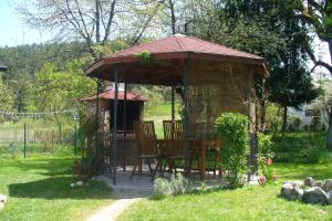 a gazebo with a table and chairs in a yard at Apartments with a parking space Otocac, Velebit - 20246 in Otočac