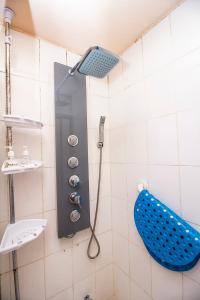 El baño incluye ducha con cabezal de ducha azul. en Departamento Freire, en Valparaíso