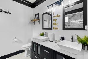 a bathroom with two sinks and a toilet at Vine City Bee Hive in Atlanta