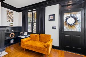 a living room with an orange couch and a door at Vine City Bee Hive in Atlanta