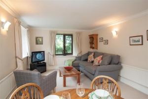 a living room with a couch and a table at Over Ghyll in Ambleside