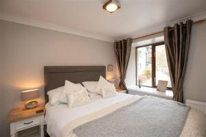 a bedroom with a large bed and a window at Over Ghyll in Ambleside