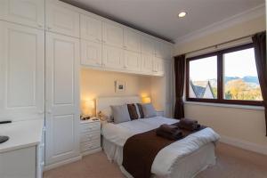 a bedroom with a bed and a window at Romney 22 in Ambleside